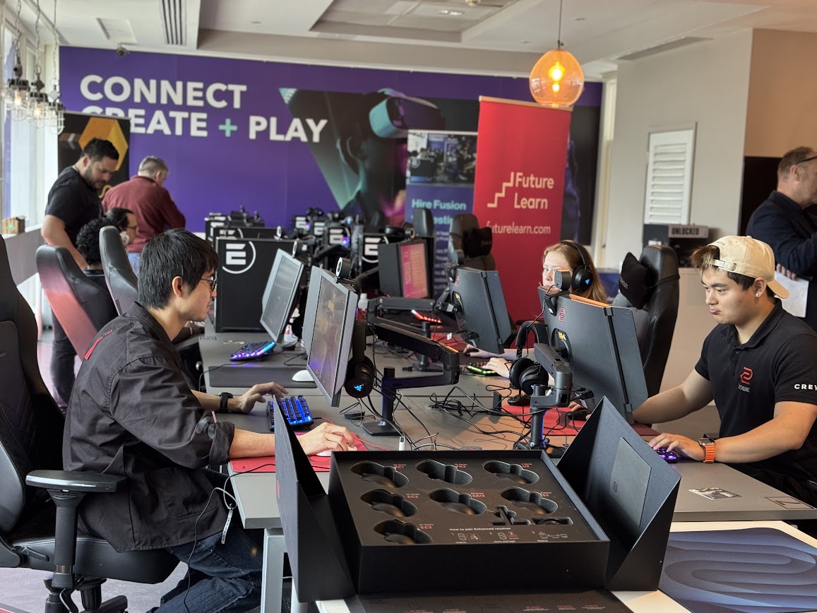 Students play testing games at the Fusion Lab gaming PCs with an open JobBox headset tray in the foreground