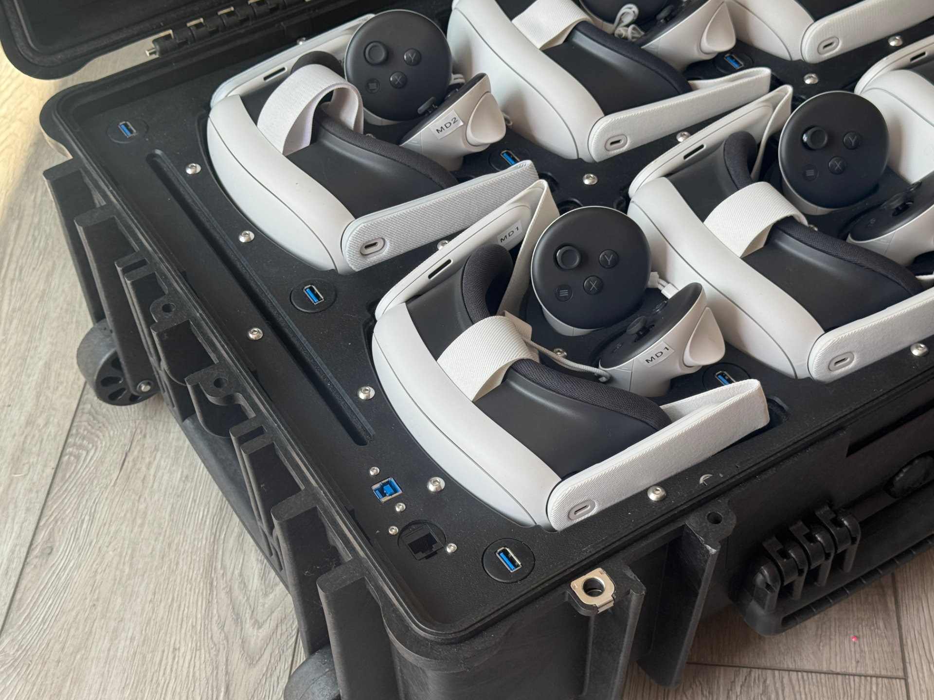 Close-up of the immersive careers fair technology inside JobBox: Meta Quest 3 headsets and controllers in the charging case with USB and network ports