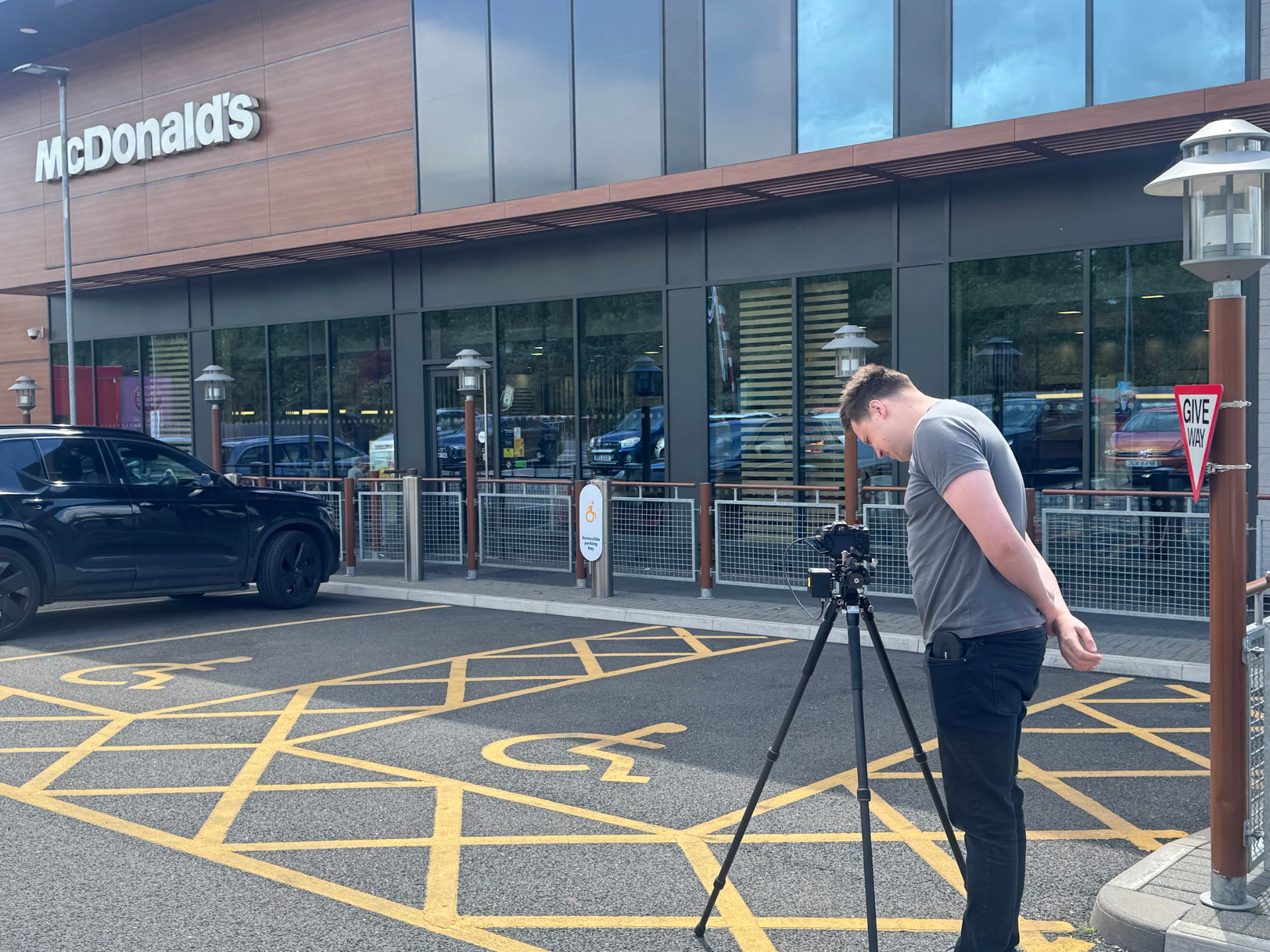 Crew member setting up the camera on a tripod outside the McDonald's entrance