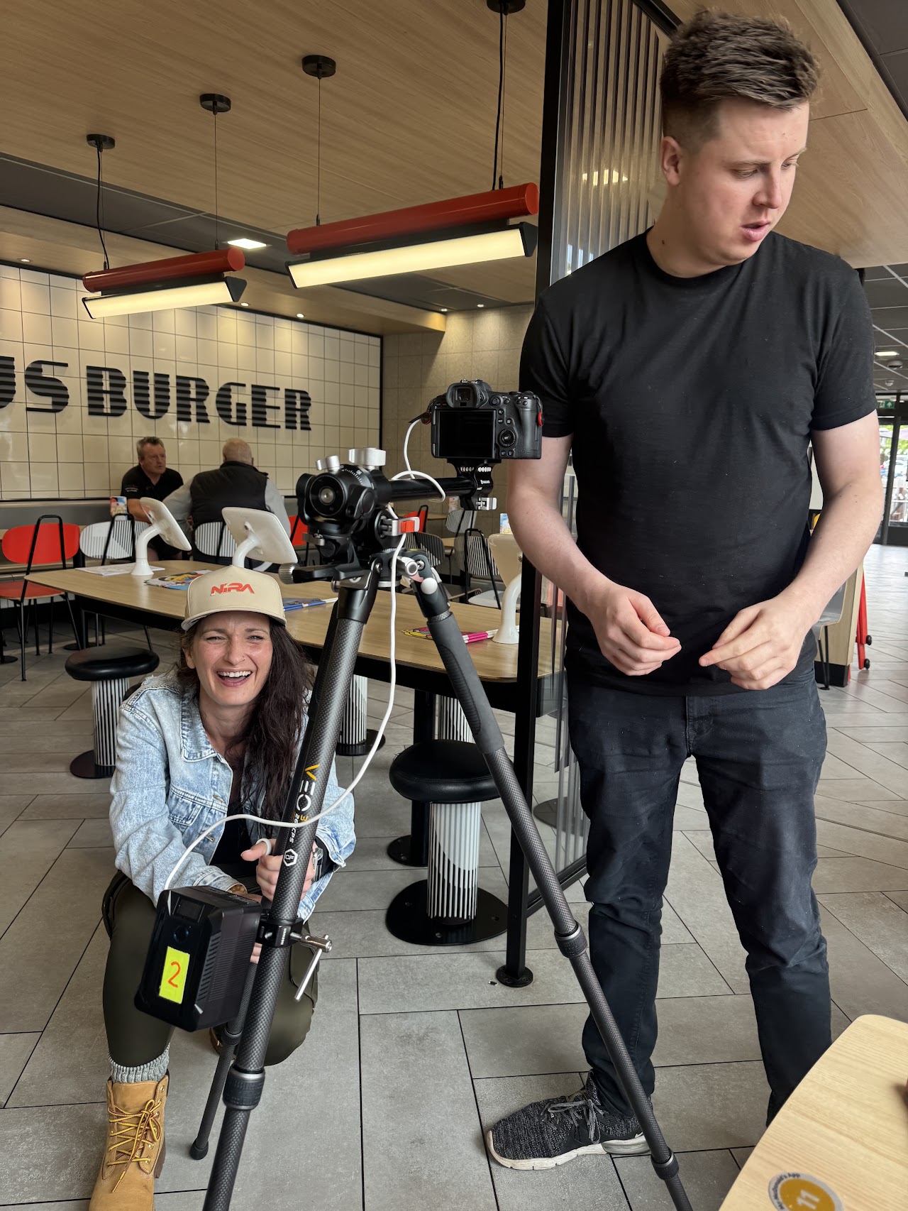 The production team working a low camera angle in the restaurant seating area