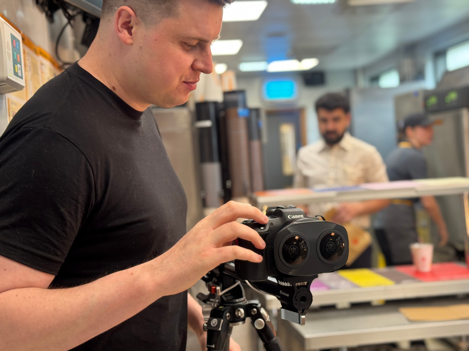Camera operator with the dual fisheye rig filming an immersive workplace video in the McDonald's kitchen