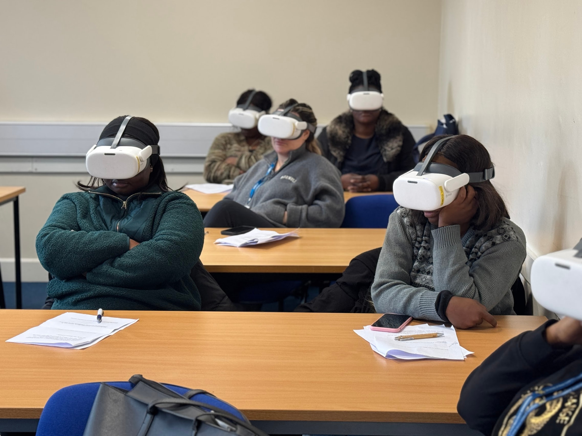 Trainee social workers seated at desks wearing VR headsets, watching the JobBox immersive workplace video